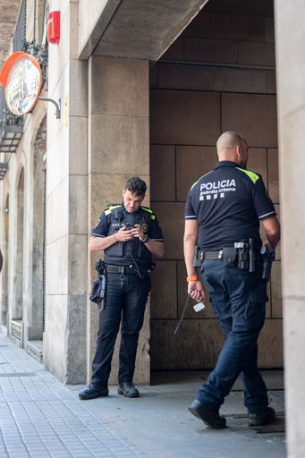 A vertical shot of Police officers in the street in Barcelona, Spain