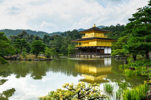 The beautiful Kinkaku-ji temple and surrounding trees reflected on the pond in Kyoto, Japan
