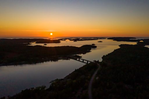 Aerial view overlooking silhouette bridge islands and islands of Geta in Aland, calm, summer evening, in Finland