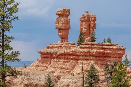 Hoodoos stand majestically under a clear sky in Bryce Canyon National Park, Utah, showcasing unique geological formations and natural beauty.