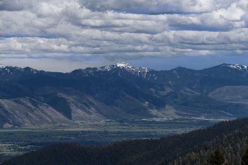 A horizontal shot of a beautiful view of a huge mountain in a natural area under cloudy sky