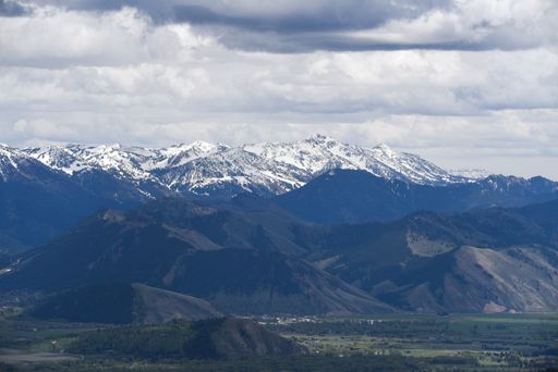 A horizontal shot of a high snowy mountain in an amazing place under the cloudy sky, winter