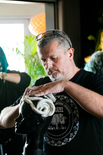 Cape Town, South Africa - April 19, 2021: Team Building workshop for hairdressers making clay sculptures of hair styles on mannequin