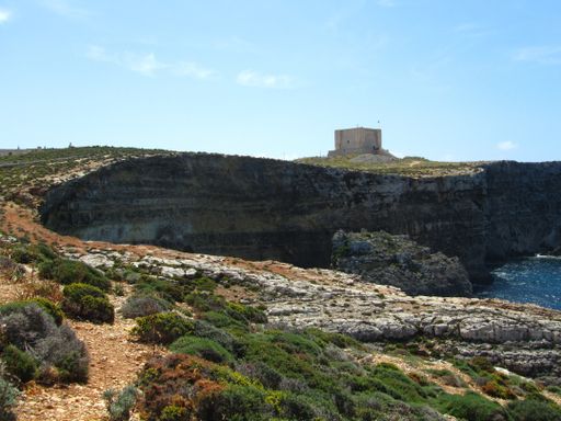 Santa Marija Tower, built by Knights Order of St John, over the cliffs and blue sea on the island of Comino, Malta. Prison in Count of Monte Cristo