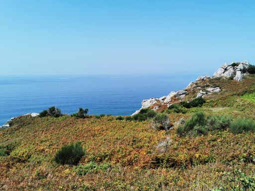 A beautiful view of the calm North Atlantic Ocean gleaming under the blue sky in Spain