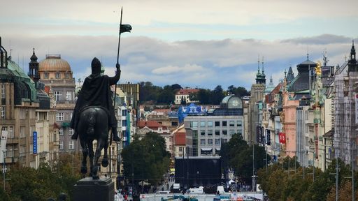 A View of Wenceslas Square in Prague featuring a historic statue and architectural buildings under a cloudy sky