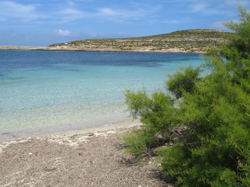 The coastline of Comino, Malta under a blue sky
