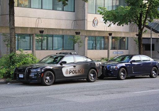 A closeup shot of cars parked near a police department in Vancouver, Canada
