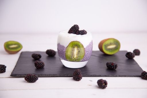 Fresh black chia pudding with blackberries and kiwi
