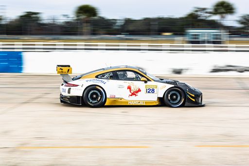 A long exposure of a Porsche race car in action on the track