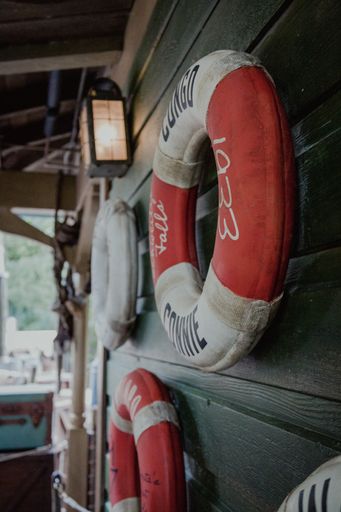 A view of lifebuoys attached to the wooden wall near the port on a sunny day