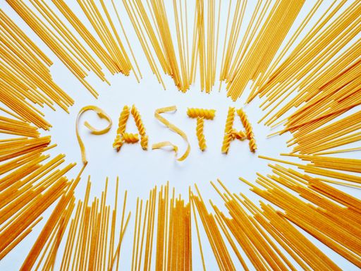 A white background design of pasta written with spaghetti