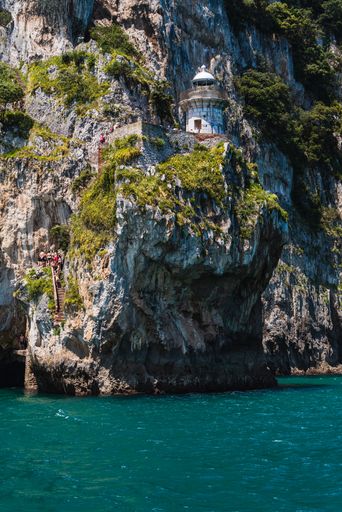 A vertical shot of a tower on a cliff in Marismas de Santona, Victoria y Joyel natural park in Spain