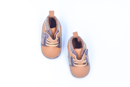 A closeup of the brown baby shoes isolated on white background.