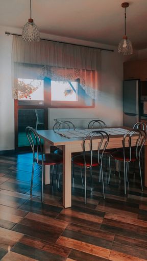A vertical shot of a kitchen interior with light flowing from windows