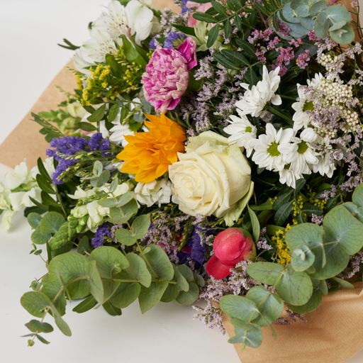 A closeup shot of a bouquet wrapped in a craft paper