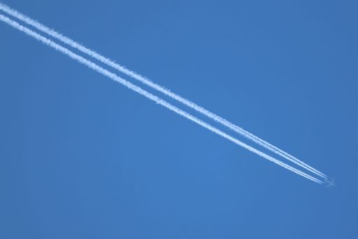A Boeing KC135 Stratotanker aircraft flying at high altitude with visible contrails