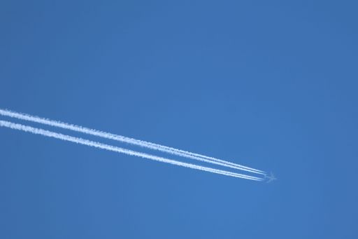 A Boeing KC-135 Stratotanker flying at 35,000 feet with visible contrails.