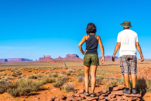 A beautiful young European couple enjoying the beautiful view of the famous Monument Valley in Utah, USA