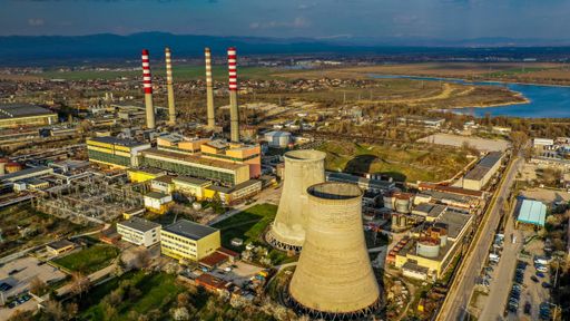 A wide angle shot of the nuclear plants of a city next to other facilities