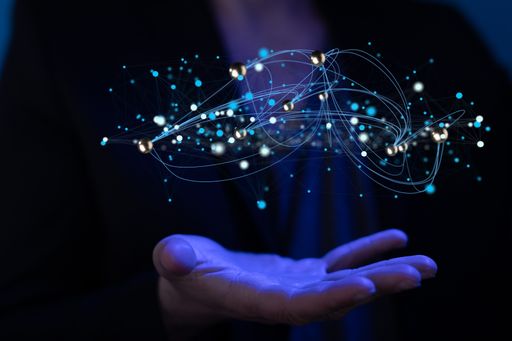 A 3d rendering of molecules abstraction hovering over a man's palm in blue light - science and unity concept