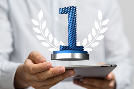 A 3D rendering of a first place golden award and male hand holding on a blurry background