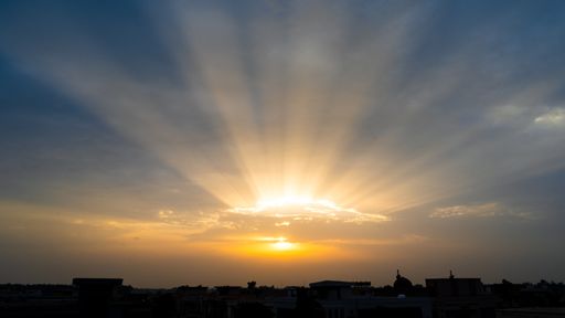 A beautiful sunrise sky and clouds with dramatic light over a city