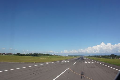 The airport free runway with hills ahead against a cloudy sky