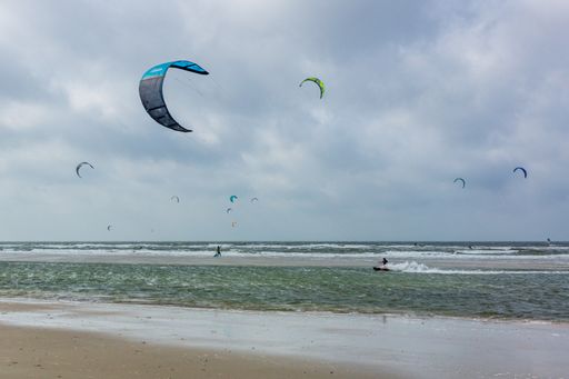 A shot of flying kite surfers on the beach of Sankt Peter Ording, Germany