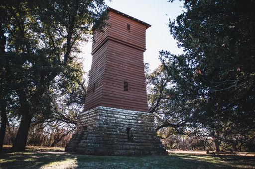 A historic water tower from the 1930s in a wooded area in the Abilene State Park in Texas, USA