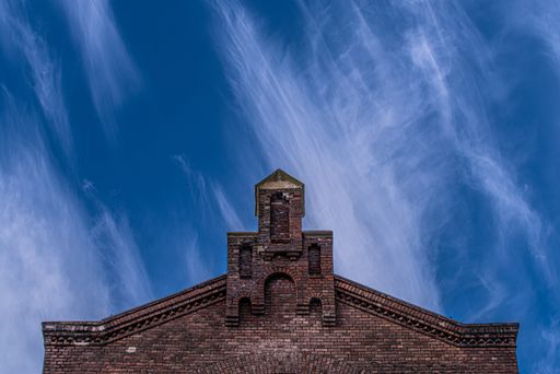 A tranquil scenery of the dome of a majestic old cathedral under a cloudy sky