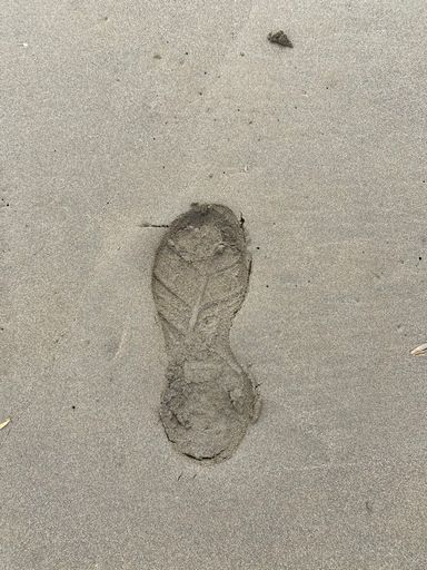 Human footsteps walking by the beach of al hoceima city in Morocco