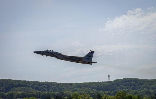 An F-15 fighter jet performing a demonstration flight at an airshow