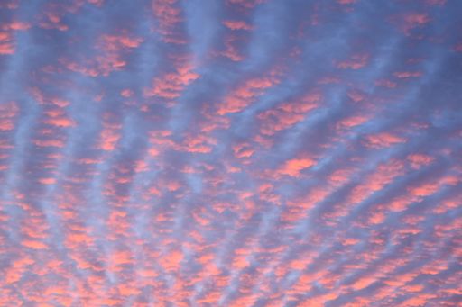 A low angle shot of a cloudy sky during a beautiful purple sunset