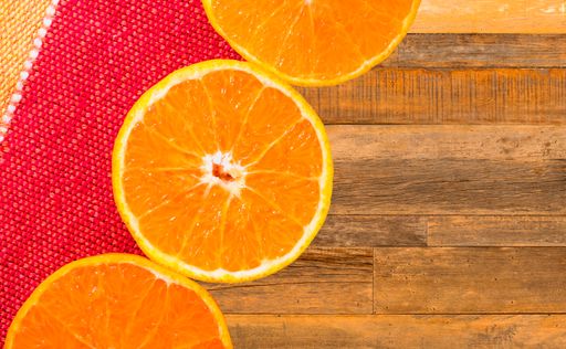 A closeup shot of sliced orange circles on a wooden surface