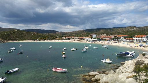 An aerial view of the cloudy sky over the sea and port in summer
