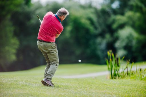 A shallow focus shot of a male playing golf