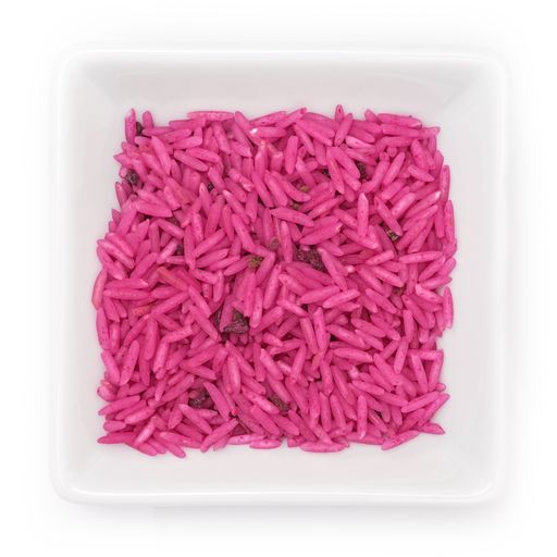 A top view of pInk-colored basmati rice in a white bowl on a white background