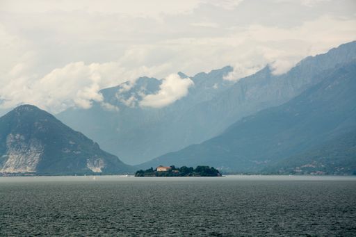 A ship sailing in the sea with mountains in the background