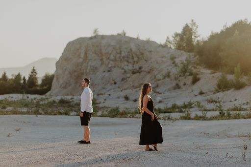 A Bosnia couple walking in the field during the daytime
