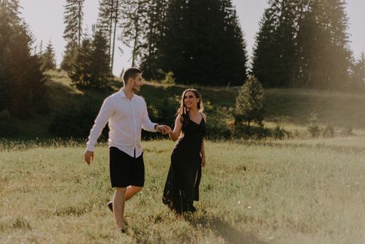 A Bosnia couple walking in the field during the daytime