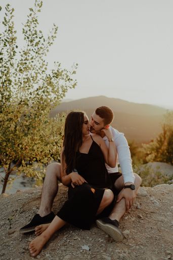 A Bosnian young loving couple hugging in the field