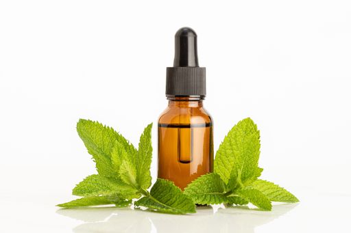 Peppermint essential oil on white background. Herbal remedies