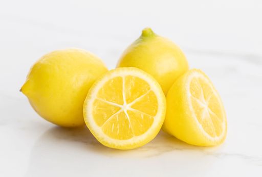 Group of dwarf lemons isolated on white marble background