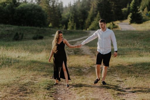 A Bosnia couple walking in the field during the daytime