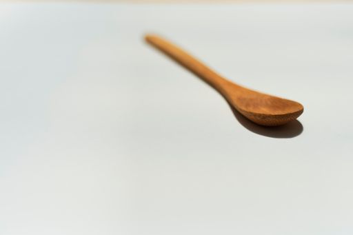 A wooden spoon on a white background with available space for your text