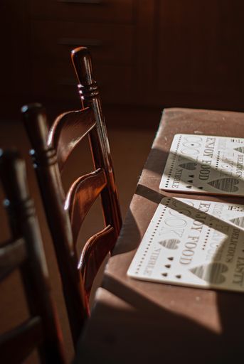 A vertical shot of the menu on a wooden table in an empty cafe