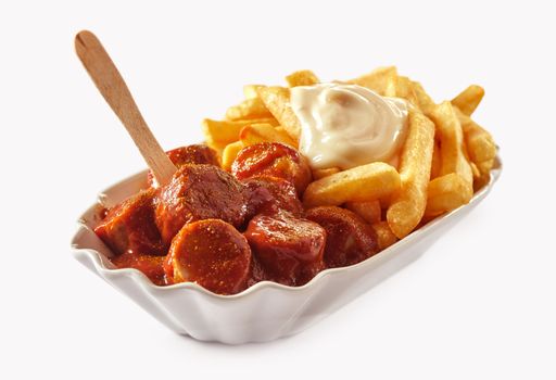 A close-up shot of a fast food meal of fried potatoes and currywurst, isolated