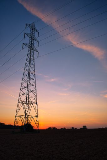 A transmission tower silhouette at sunset