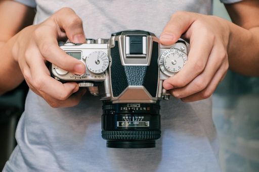 A person holding a digital camera